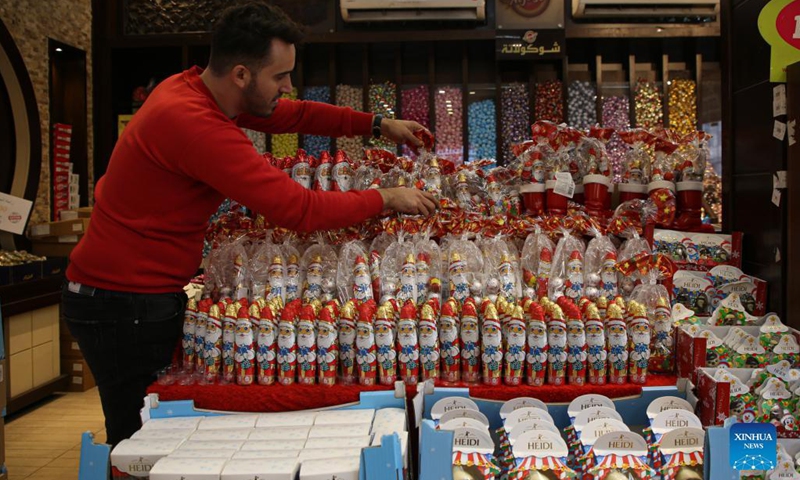 A Palestinian seller works on decorations at a store for the upcoming Christmas holiday in Gaza City, on Dec. 6, 2021.(Photo: Xinhua)