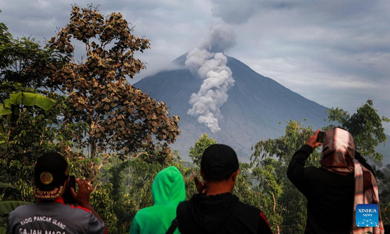 People watch the Mount Semeru from Sapiturang Village in Lumajang, East Java, Indonesia, Dec. 7, 2021. The death toll from the eruption of Mount Semeru has risen to 34, according to a local official.(Photo: Xinhua)