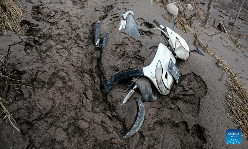 A motorbike is seen buried with volcanic ash after the Mount Semeru eruption in Curah Kobokan Village of Lumajang, East Java, Indonesia, Dec. 7, 2021. The death toll from the eruption of Mount Semeru has risen to 34, according to a local official. (Photo: Xinhua)