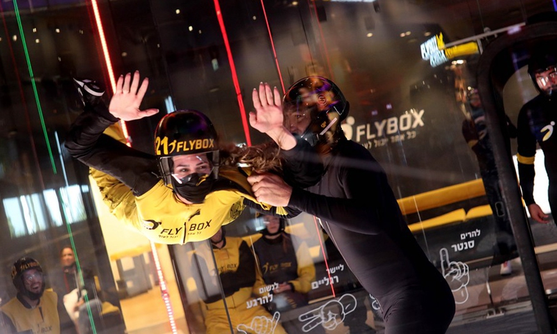 An Israeli woman practices indoor skydiving in a wind tunnel in Rishon Lezion, Israel, Dec. 9, 2021.(Photo: Xinhua)