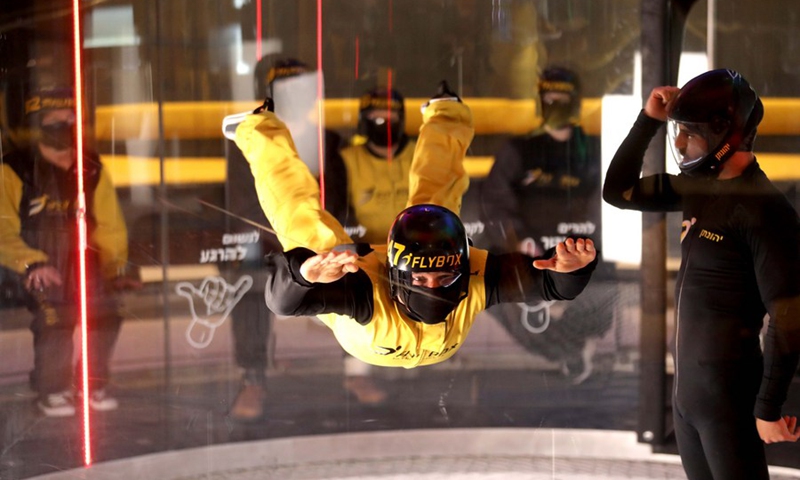 An Israeli man practices indoor skydiving in a wind tunnel in Rishon Lezion, Israel, Dec. 9, 2021.(Photo: Xinhua)