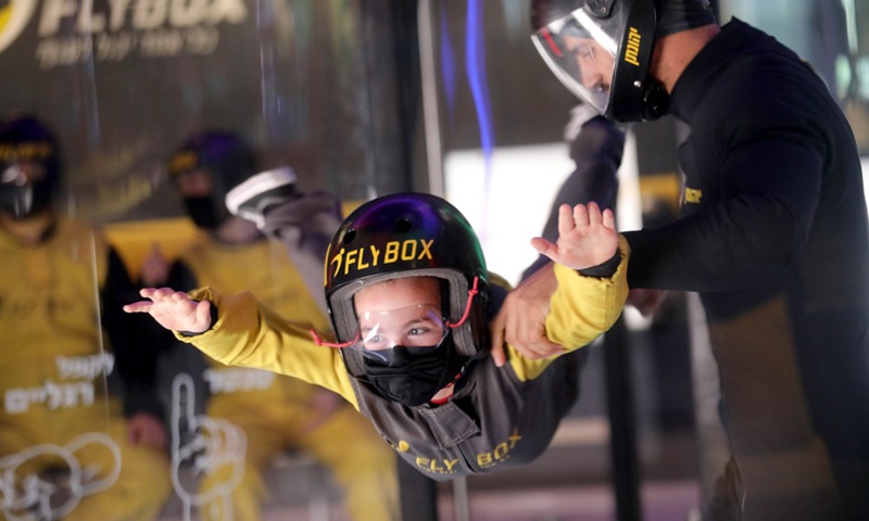 An Israeli child practices indoor skydiving in a wind tunnel in Rishon Lezion, Israel, Dec. 9, 2021.(Photo: Xinhua)