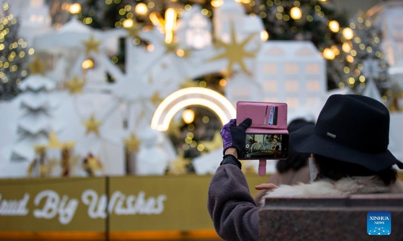 A woman takes a photo of Christmas installations in Seoul, South Korea, Dec. 11, 2021.Photo:Xinhua