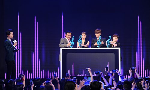 Tencent Vice President Sun Zhonghuai (left behind podium), singer Elva Hsiao, Show Lo and Editor-in-Chief of Tencent Video Wang Juan attend the launch ceremony for Tencent Video's Live Music on Friday in Beijing.
Photos: Courtesy of Tencent Video