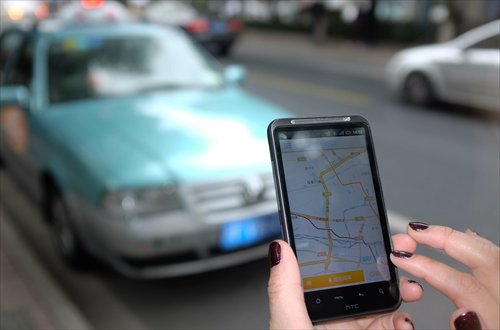 A person in Shanghai uses a car-hailing app to call a taxi. Photo: CFP