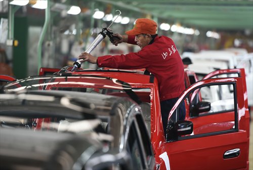 An employee works on an electronic vehicle at a factory in Zouping, East China's Shandong Province. Photo: CFP