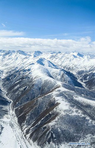 Aerial view of snow-covered Bayan Har Mountains in China's Qinghai ...