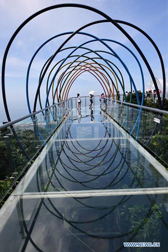 Tourists go sightseeing on sea-view glass skywalk in Sanya, S China ...