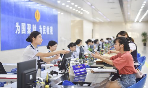 The staff members of Taxation Bureau of Quanzhou, Southeast China's Fujian Province,handling business for taxpayers on Friday. Photo: Xinhua