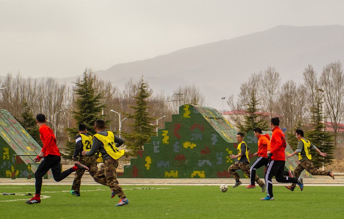 a football game between pla soldiers on the roof of the world