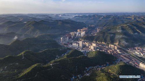 Aerial photo taken on Aug. 10, 2019 shows a view of Ansai District of Yan'an, northwest China's Shaanxi Province. The city of Yan'an on the Loess Plateau, where 258 million tonnes of mud and sand were once washed into the Yellow River each year, has seen its landscape improve greatly. Since 1999, local government has returned 718,307 hectares of farmland to forests, increasing the local vegetation coverage rate from 46 percent in 2000 to over 80 percent at present. Data showed that the city reported fewer sand and dust days in recent years, and the annual amount of mud and sand washed into the Yellow River has been slashed by 88 percent to 31 million tonnes.(Photo: Xinhua)