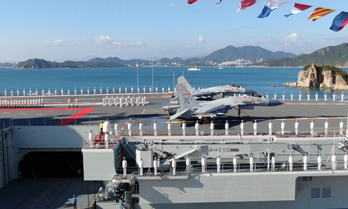 The commissioning ceremony of Shandong aircraft carrier is held at a naval port in Sanya, south China's Hainan Province, Dec. 17, 2019. China's first domestically built aircraft carrier, <em>the Shandong</em>, was delivered to the People's Liberation Army (PLA) Navy and placed in active service on Dec. 17 at a naval port in Sanya. The new aircraft carrier, named after Shandong Province in east China, was given the hull number 17. (Xinhua/Li Gang)