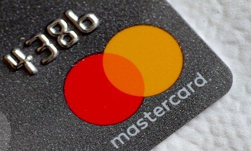A Mastercard logo is seen on a credit card. File Photo: VCG