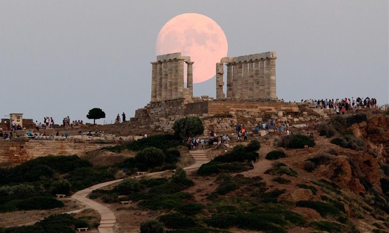 View of full moon rising over ancient Temple of Poseidon in Greece ...