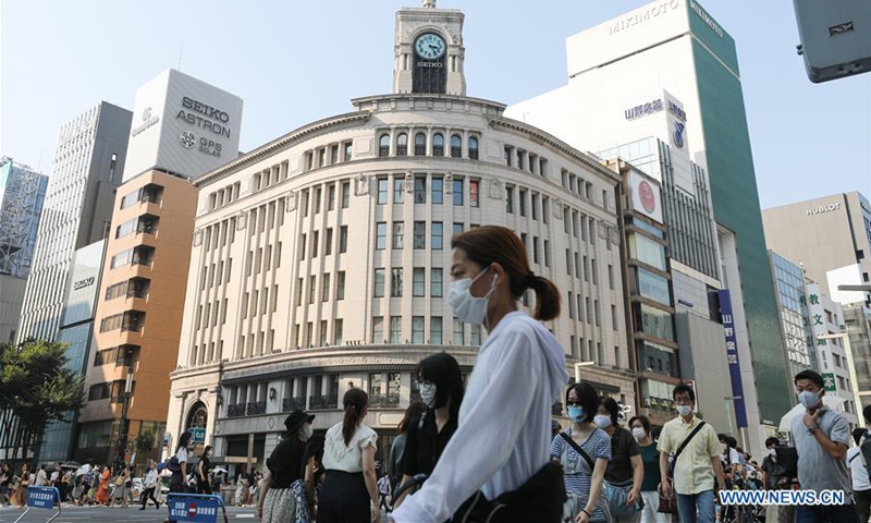 People wearing face masks walk on the street at Ginza in Tokyo, Japan, on Aug. 15, 2020. (Xinhua/Du Xiaoyi) 