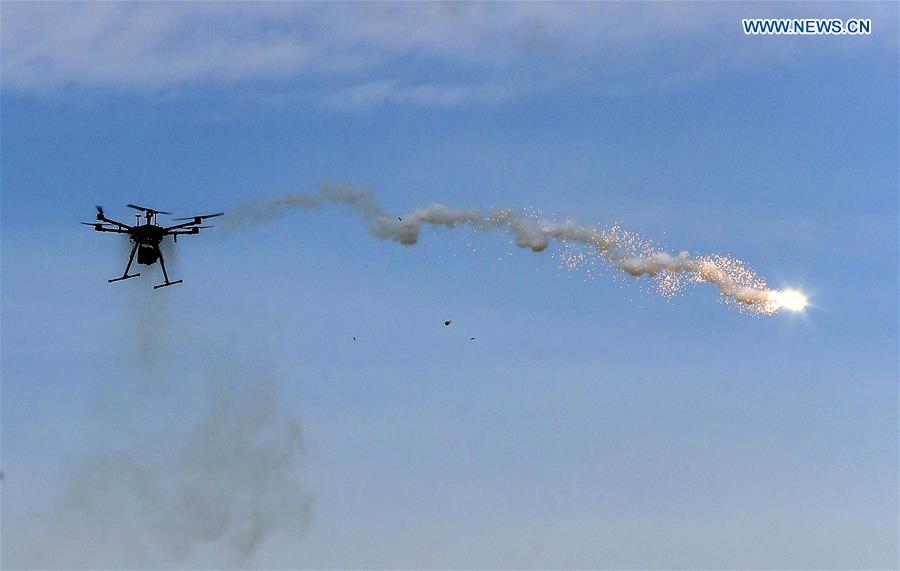 An unmanned aerial vehicle (UAV) drops an illuminating projectile during the achievement presentation of the police UAV training courses for senior police officers in Anshan, northeast China's Liaoning Province, Sept. 29, 2020. The achievement presentation of the police UAV training courses for senior police officers across the country was held in Anshan on Tuesday. Several practical and actual combat drills, including aerial reconnaissance, precise targeting of relief goods, collaborative application of police UAVs and acquisition of geographic information, were displayed during the presentation. (Xinhua/Yin Gang)