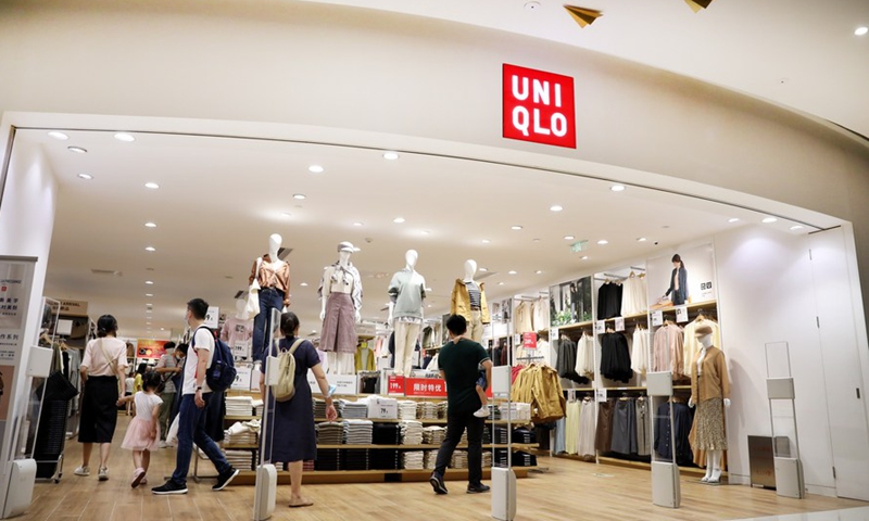 People shop at a retail store of Uniqlo in east China's Shanghai, Aug. 28, 2020. (Xinhua/Fang Zhe)