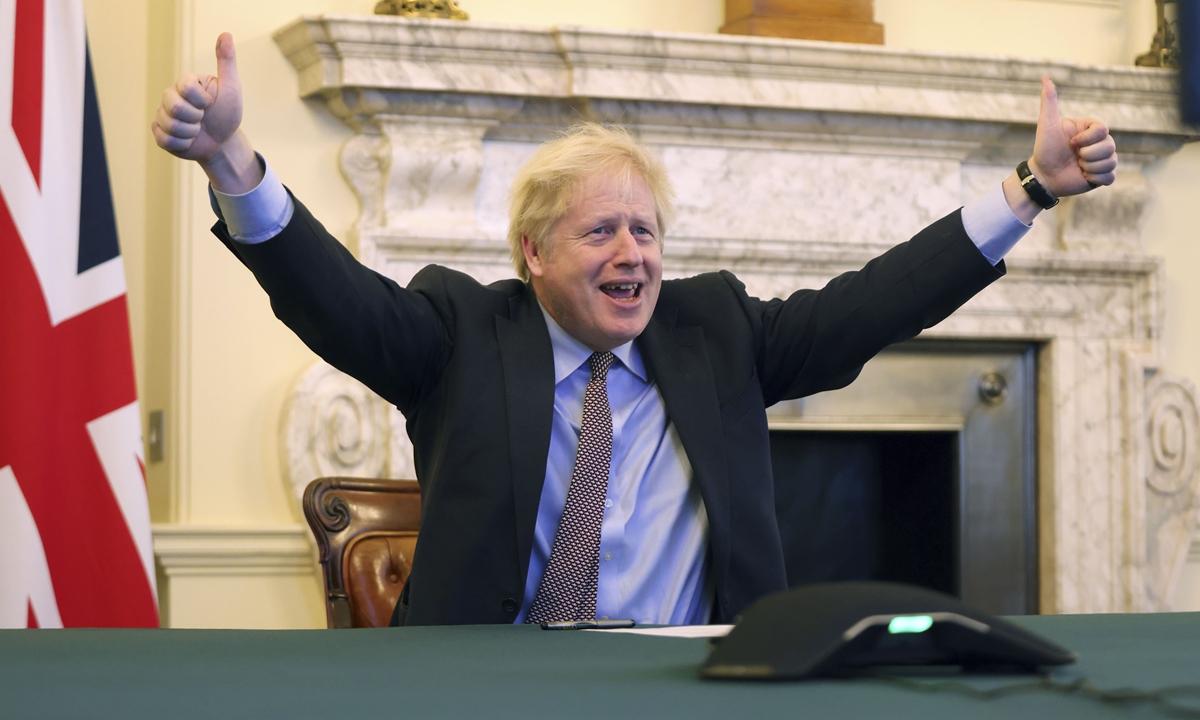 British Prime Minister Boris Johnson celebrates the agreement between the UK and the EU at his office in London on Thursday. Britain said on the same day that an agreement had been secured on the country's future relationship with the European Union, after last-gasp talks just days before a cliff-edge deadline. Photo: Xinhua