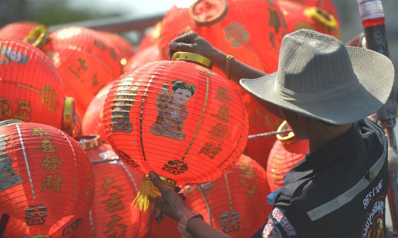 Staff members arrange lanterns to decorate street for upcoming Chinese