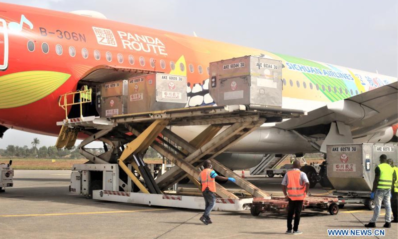 Workers unload the COVID-19 vaccine donated by China at an airport in Freetown, Sierra Leone, on Feb. 25, 2021. Sierra Leone on Thursday received a consignment of 200,000 doses of China's Sinopharm COVID-19 vaccine donated by China to support the country's vaccination campaign. (Photo by Abu/Xinhua)