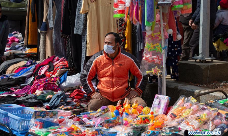 A vendor wearing a face mask waits for customers at a market in Srinagar city, the summer capital of Indian-controlled Kashmir, Feb. 28, 2021.(Photo: Xinhua)