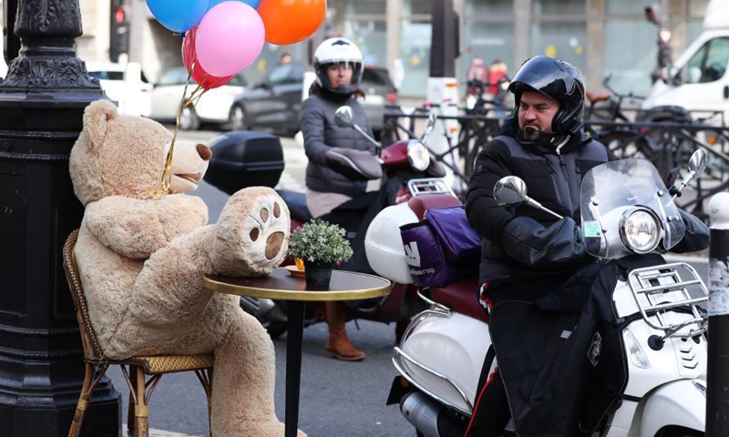 A man riding a motorbike looks at a giant teddy bear outside a restaurant in Paris, France, March 3, 2021. Giant teddy bears are seen at a restaurant which offers take away services in Paris. Restaurants, bars and cafes haved been all forced to shut down when the country entered into its second lockdown on Oct. 30, 2020.Photo:Xinhua