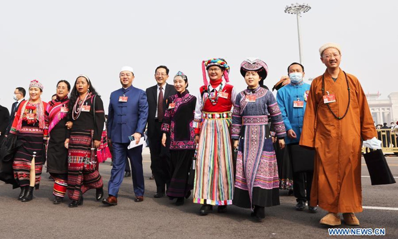 Members of the 13th National Committee of the Chinese People's Political Consultative Conference (CPPCC) walk towards the Great Hall of the People for the opening meeting of the fourth session of the 13th CPPCC National Committee in Beijing, capital of China, March 4, 2021. (Xinhua/Cao Can)