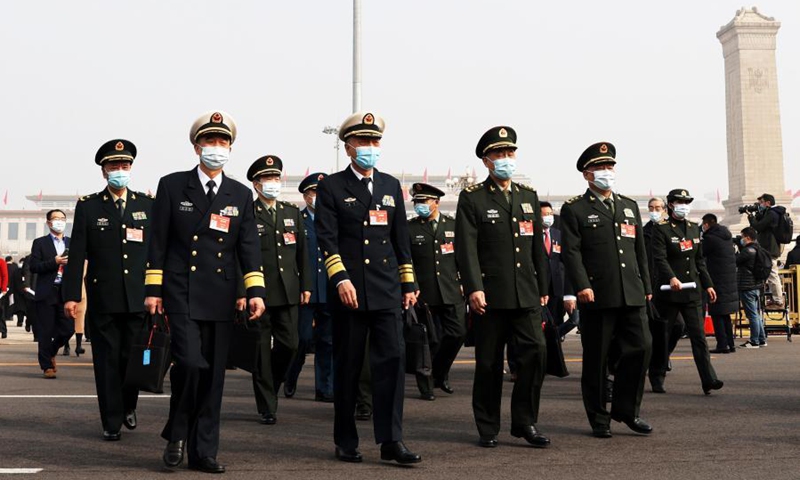 Members of the 13th National Committee of the Chinese People's Political Consultative Conference (CPPCC) walk towards the Great Hall of the People for the opening meeting of the fourth session of the 13th CPPCC National Committee in Beijing, capital of China, March 4, 2021. (Xinhua/Cao Can) 