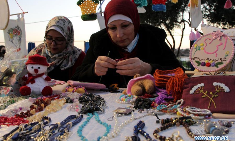 Palestinian women make their handicrafts at a handicraft exhibition in Gaza City, on March 6, 2021.(Photo: Xinhua)