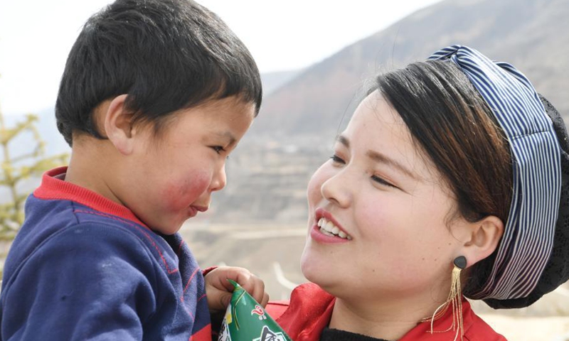 Ma Linhong holds her child during rest time at noon in Nanyangwa Village of Dongxiang Autonomous County of Linxia Hui Autonomous Prefecture, northwest China's Gansu Province, March 4, 2021.Photo:Xinhua