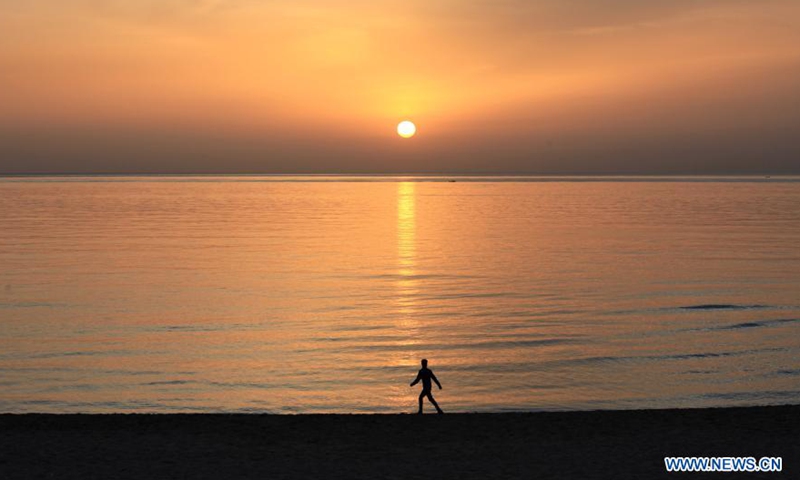 A man walks at a seaside during sunset in Beirut, Lebanon, March 10, 2021.Photo:Xinhua