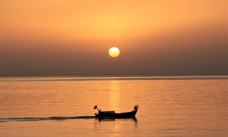 A man on a boat is seen at a seaside during sunset in Beirut, Lebanon, March 10, 2021.Photo:Xinhua