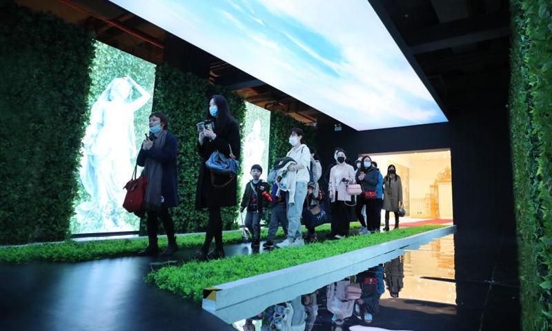 Visitors walk in an exhibition hall themed on the garden of the Versailles palace during an exhibition in Shanghai, east China, March 12, 2021. A China itinerant exhibition of Versailles palace is held at Xintiandi commercial complex in Shanghai, during which digital technologies and interactive activities offer people the unique experience of visiting the palace.  Photo:Xinhua