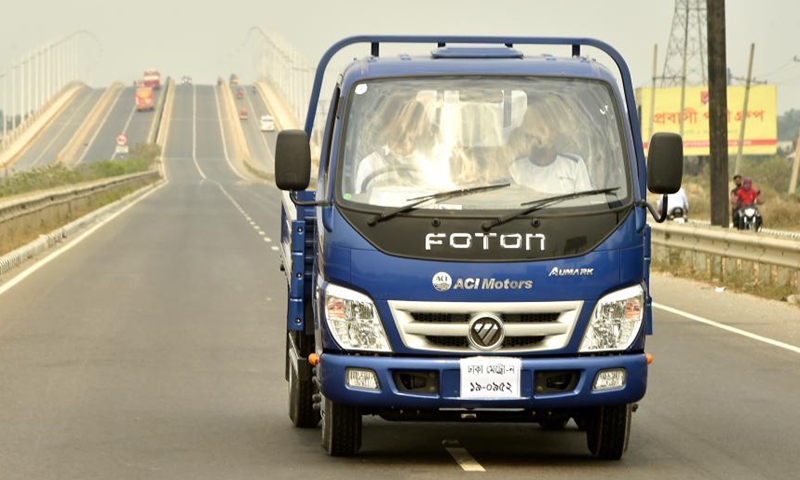 Customers take a test drive of Foton commercial vehicle on a highway in Munshiganj, Bangladesh on March 9, 2021. Foton vehicles are gaining popularity in Bangladesh, pickups in particular. Selling of commercial vehicles is on the rise in Bangladesh with the upgrading of roads in the country's rural areas. TO GO WITHFoton commercial vehicles gain popularity in Bangladesh Photo: Xinhua