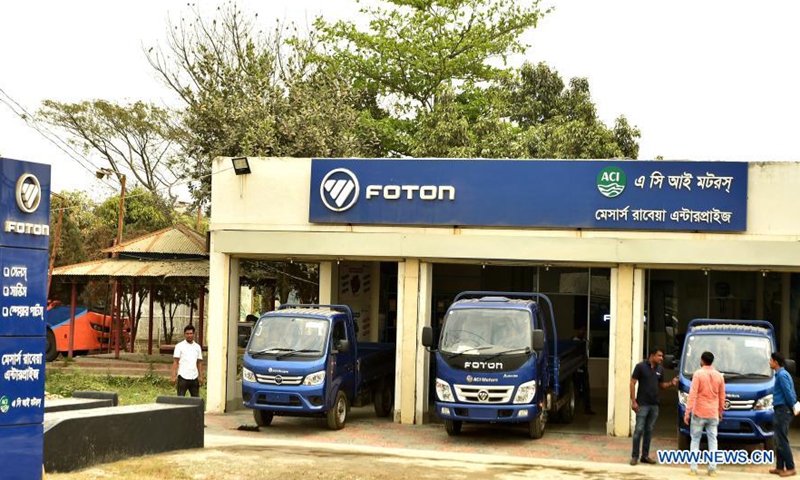 Customers learn about Foton commercial vehicle at a sales center in Munshiganj, Bangladesh on March 9, 2021. Foton vehicles are gaining popularity in Bangladesh, pickups in particular. Selling of commercial vehicles is on the rise in Bangladesh with the upgrading of roads in the country's rural areas. TO GO WITHFoton commercial vehicles gain popularity in Bangladesh  Photo: Xinhua