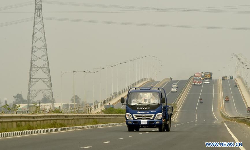 Customers take a test drive of Foton commercial vehicle on a highway in Munshiganj, Bangladesh on March 9, 2021. Foton vehicles are gaining popularity in Bangladesh, pickups in particular. Selling of commercial vehicles is on the rise in Bangladesh with the upgrading of roads in the country's rural areas. TO GO WITHFoton commercial vehicles gain popularity in Bangladesh Photo: Xinhua