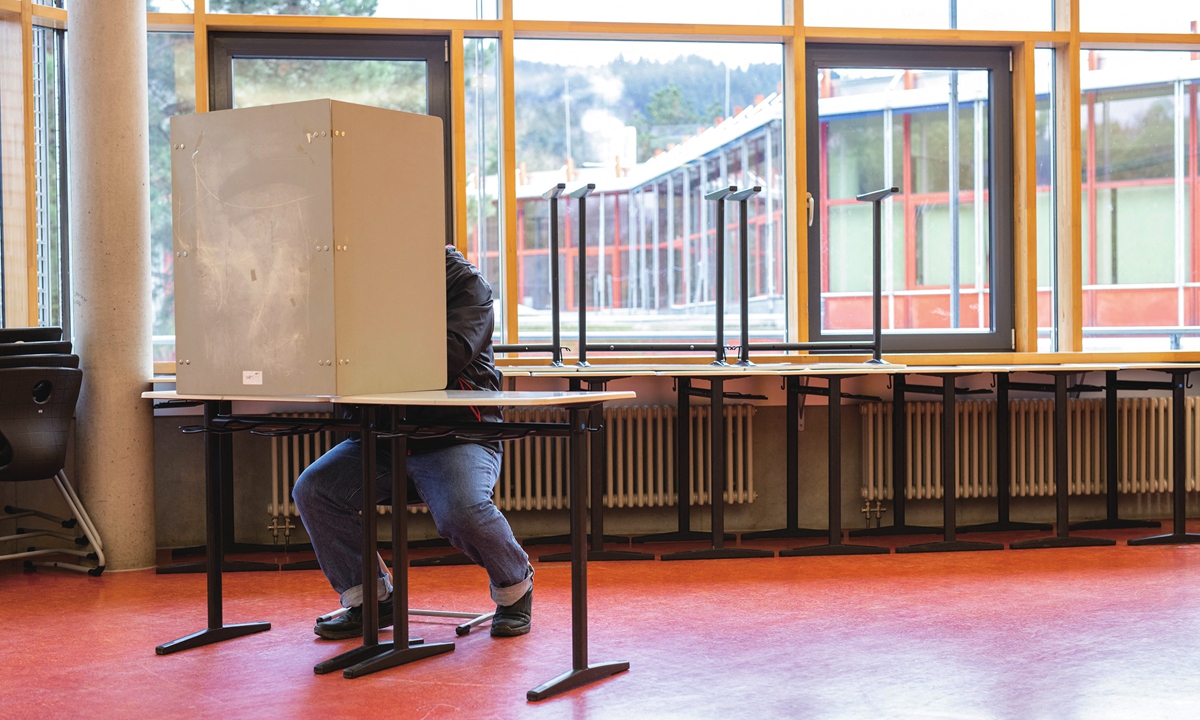 A voter sits in the polling station in the Franco-German Gymnasium and casts his vote in Freiburg, Germany, on Sunday. Today, the citizens of Baden-Württemberg are called to vote for a new state parliament. German media has dubbed 2021 