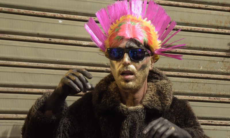 A man with painted body wears a pink hat at the annual Zambo carnival in El Mina, a coastal city in northern Lebanon, on March 14, 2021.(Photo: Xinhua)