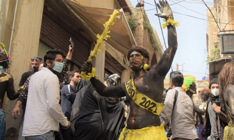 People celebrate the traditional Zambo carnival in El Mina, a coastal city in northern Lebanon, on March 14, 2021.(Photo: Xinhua)