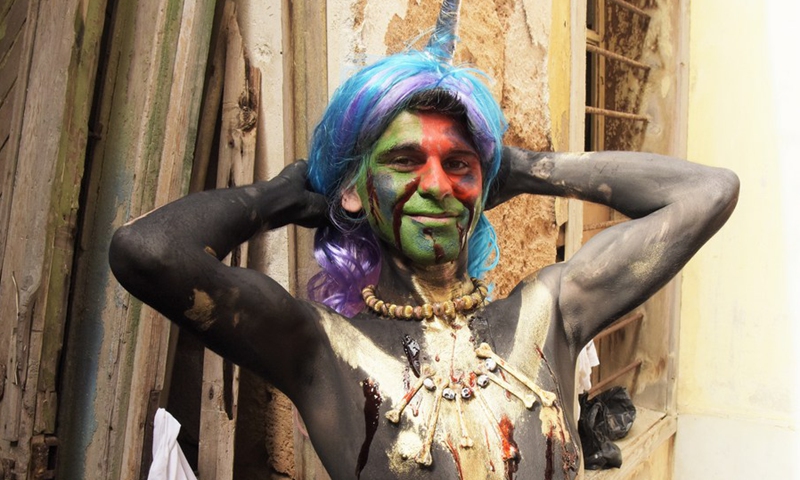 A man with body paint and bizarre decorations takes part in the traditional Zambo carnival in El Mina, a coastal city in northern Lebanon, March 14, 2021.(Photo: Xinhua)