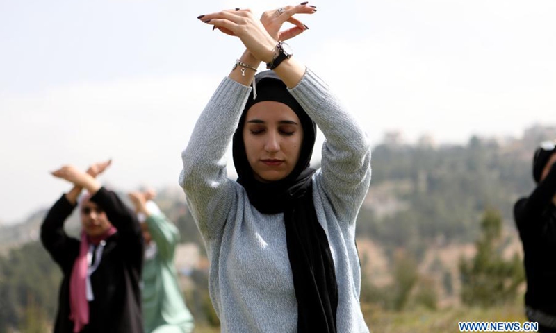 Palestinian women practice Yoga in the open air in the West Bank village of Dura near Hebron, March 16, 2021.(Photo: Xinhua)