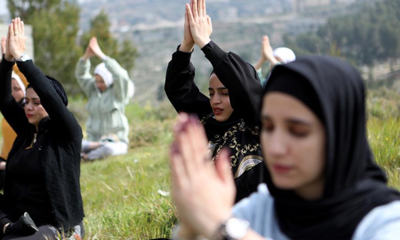 Palestinian women practice Yoga in the open air in the West Bank village of Dura near Hebron, March 16, 2021.(Photo: Xinhua)