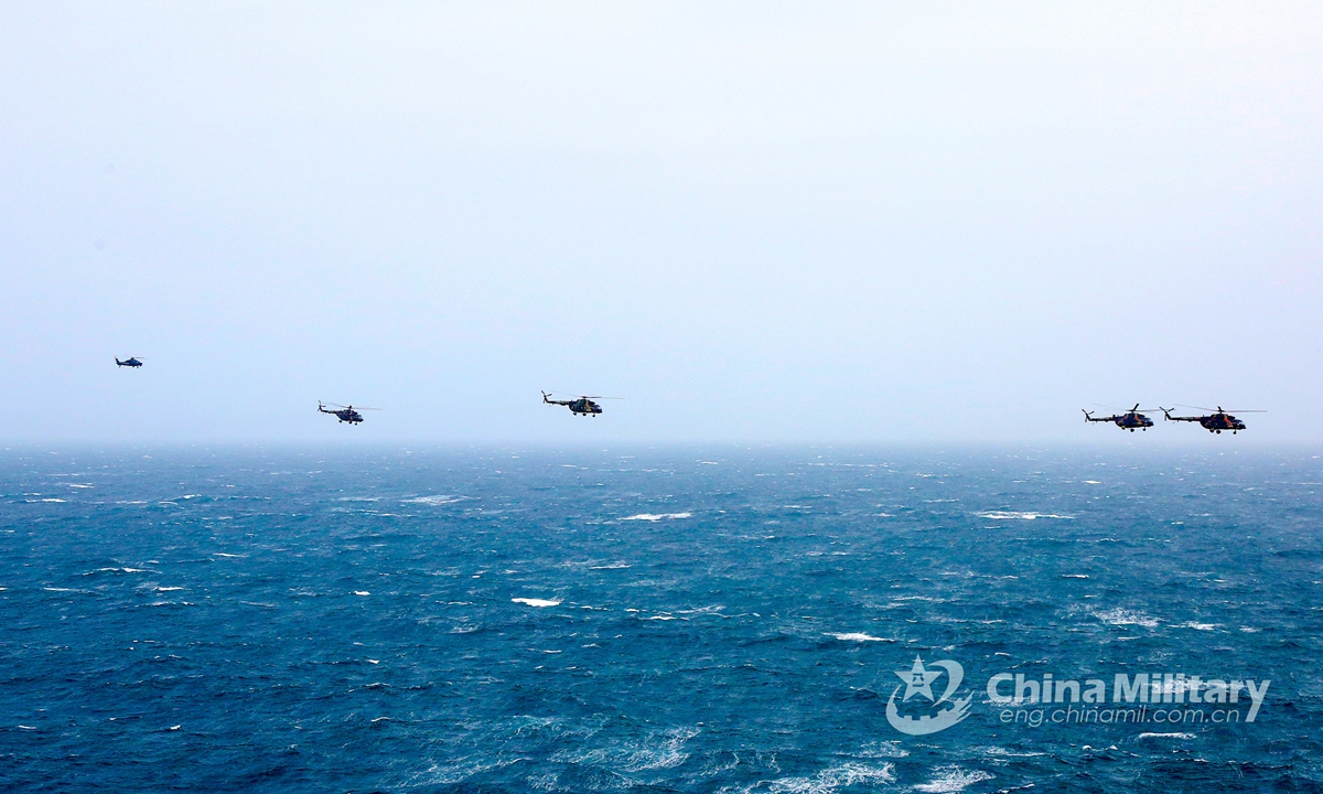 A cluster of helicopters attached to an army aviation brigade under the PLA 72th Group Army fly in close formation during a joint training exercise with a unit of PLA Navy on January 28, 2021.Photo:China Military Online