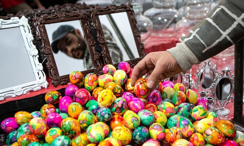 A man buys colorful eggs at a bazaar ahead of Nowruz, the Iranian New Year, in Tehran, Iran, March 18, 2021. Photo: Xinhua