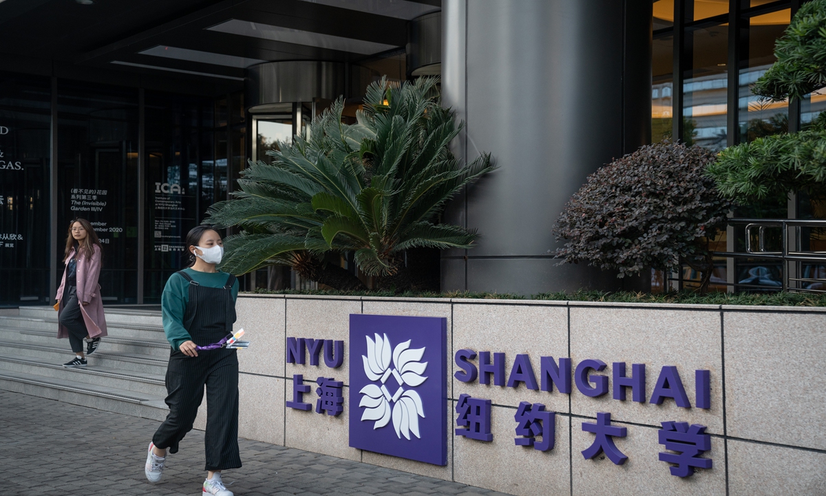 A woman walks past the entrance to NYU Shanghai. Photo: VCG