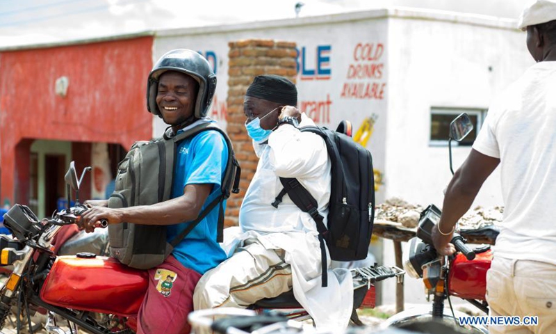 A motorcycle taxi operator carries a passenger in Blantyre, Malawi, on March 17, 2021. Motorcycle taxi is likely to boom in Malawi as the government announced it will remove duty on motorcycles in efforts to promote the motorcycle taxi locally known as Kabaza in Malawi.(Photo: Xinhua)