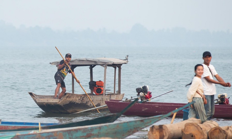 Local people use the small boats for transportation on the Mekong River in the Si Phan Don, Laos, on March 18, 2021.(Photo: Xinhua)