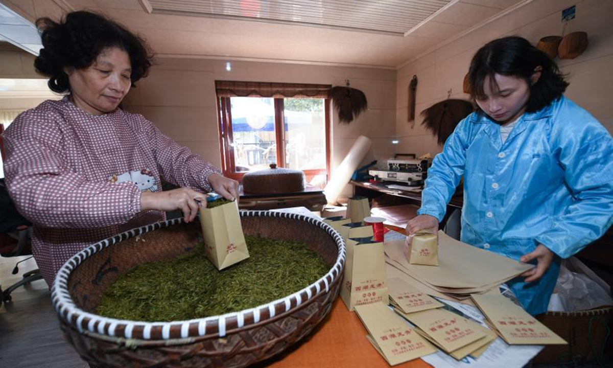 Farmers package Longjing tea at Meijiawu Village of Hangzhou City, east China's Zhejiang Province, March 23, 2021. Longjing tea, also known as West Lake Dragon Well tea, is characterized by its green color, delicate aroma, mellow taste and beautiful shape. (Xinhua/Xu Yu)