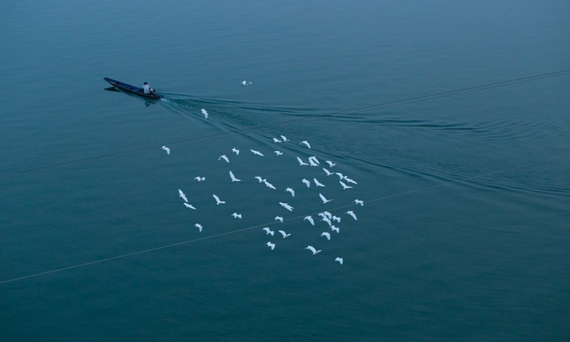 A local resident is fishing on the Mekong River in the Si Phan Don, Laos, on March 17, 2021.(Photo: Xinhua)