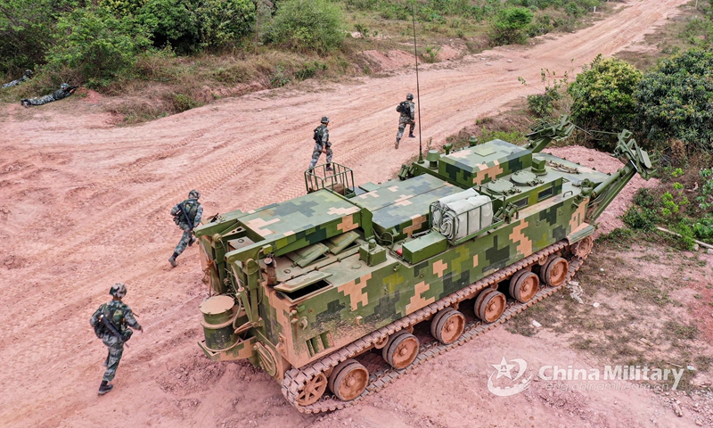 An engineering vehicle attached to an engineer element under the PLA 72nd Group Army clears route for soldiers during the breaching training in hilly area on March 22, 2021.Photo:China Military